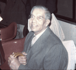 Unknown smiling man seated with cane